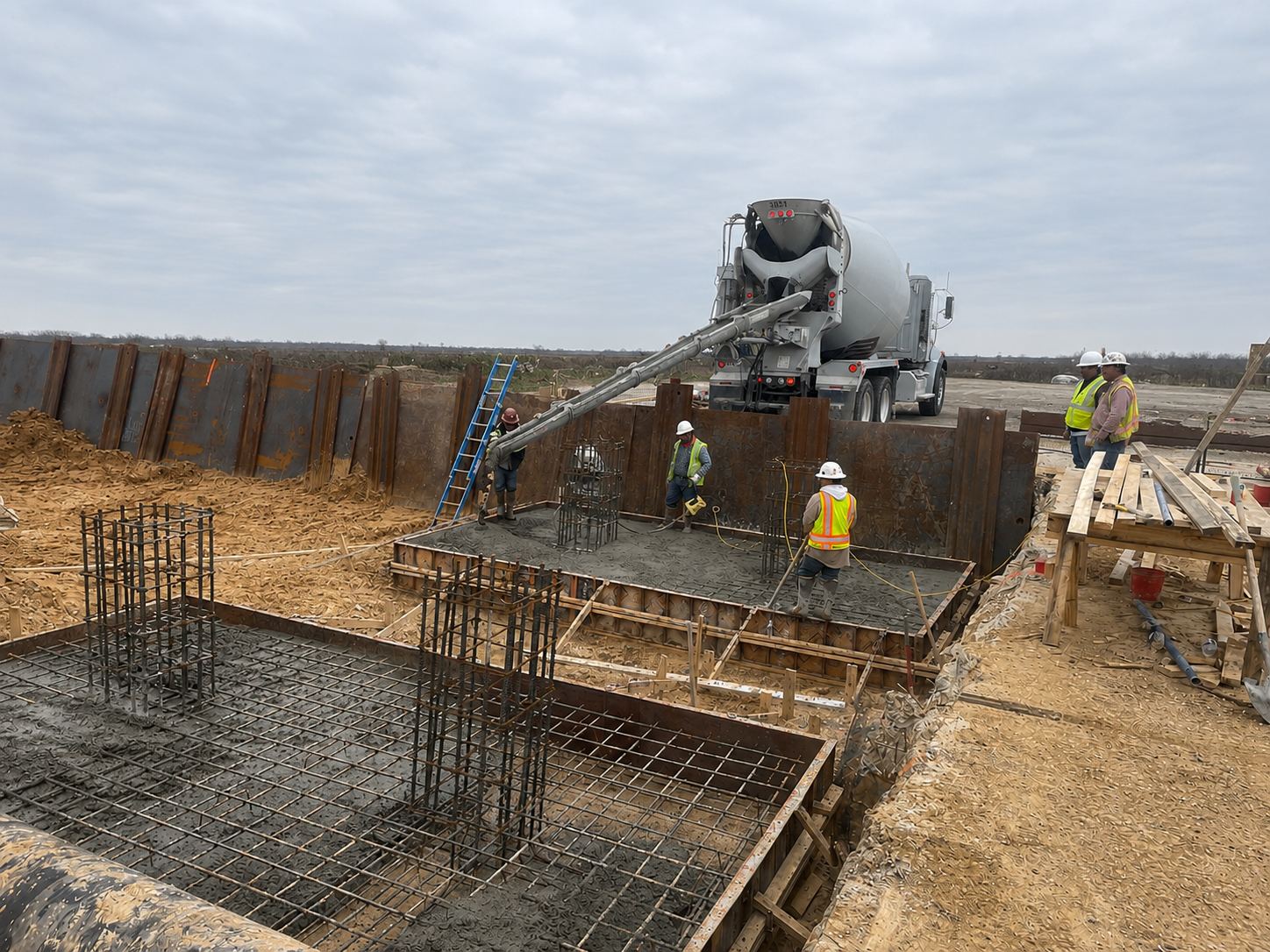 Crew placing concrete for equipment foundations