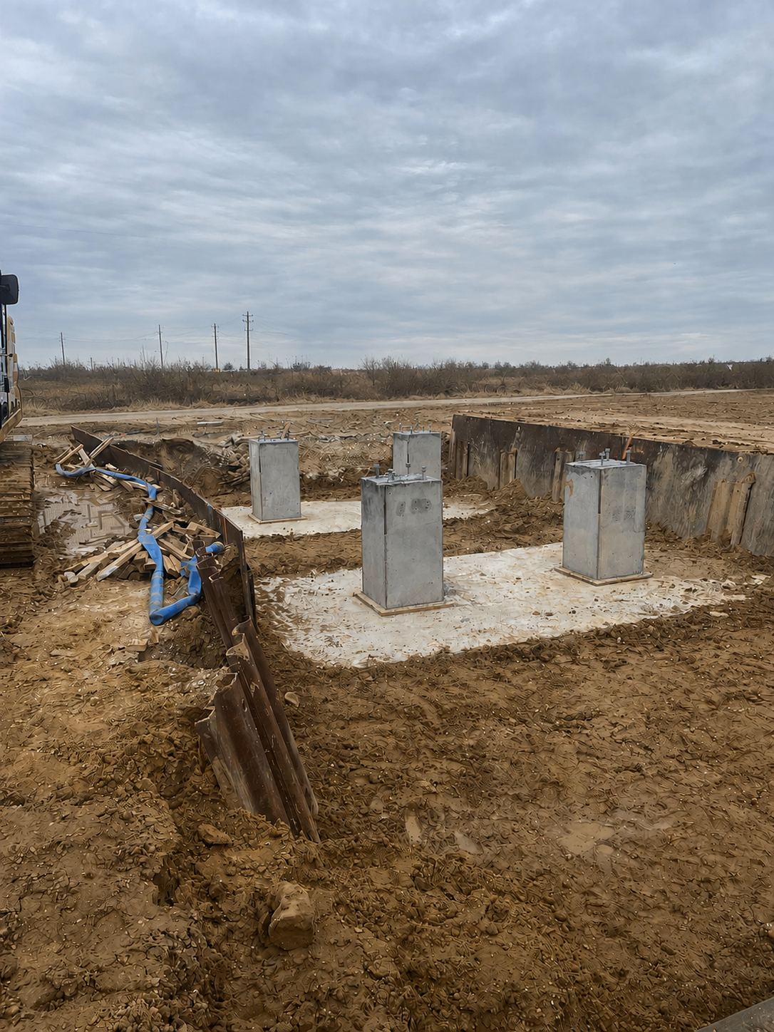 Finished concrete piers with anchor bolts ready for structural steel
